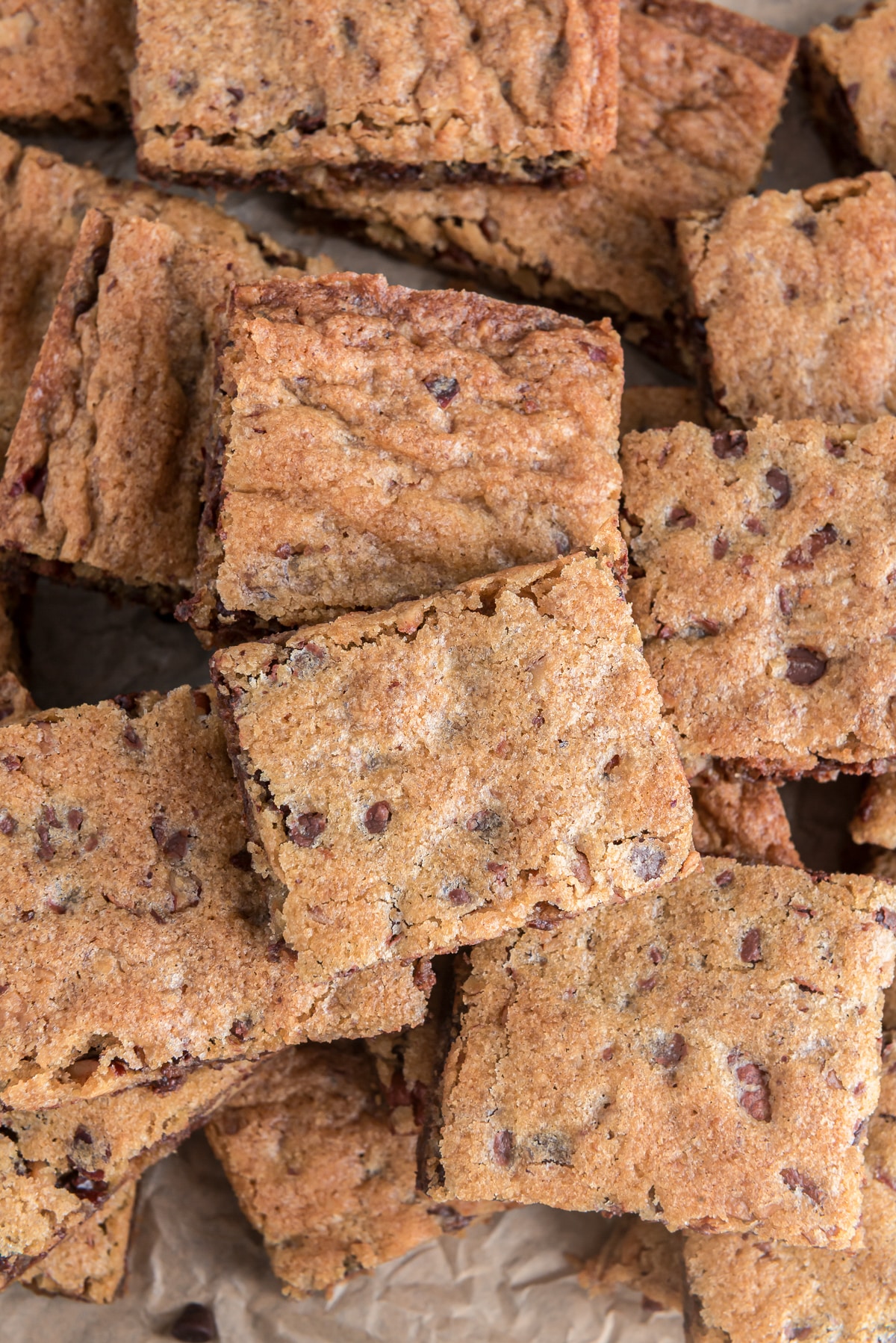 Nutty chocolate chip bars on a sheet of parchment paper.