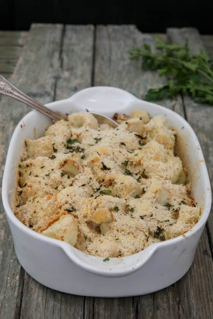 Breaded parmesan cauliflower in a white baking dish.