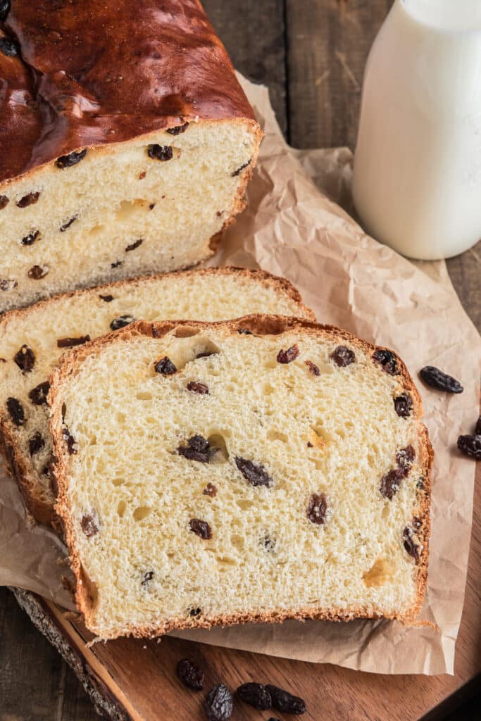 Raisin bread sliced on a board.