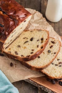 Raisin bread sliced on a board.