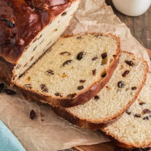 Raisin bread sliced on a board.