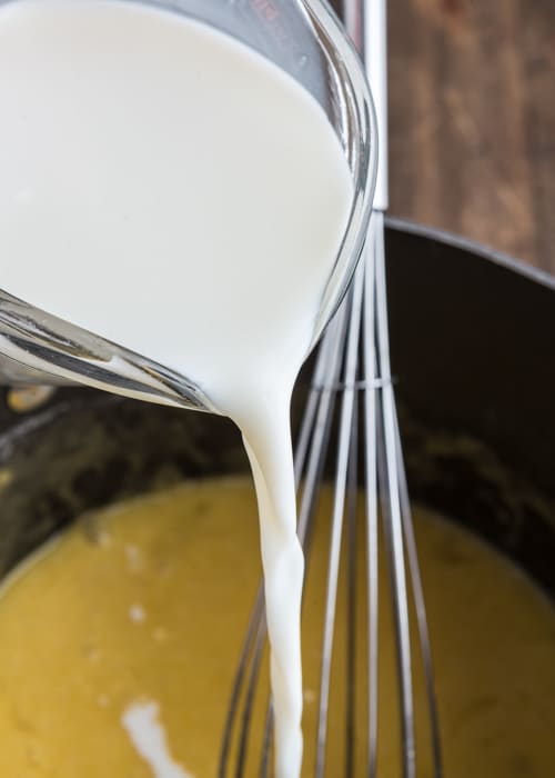 Adding the milk to the egg mixture.