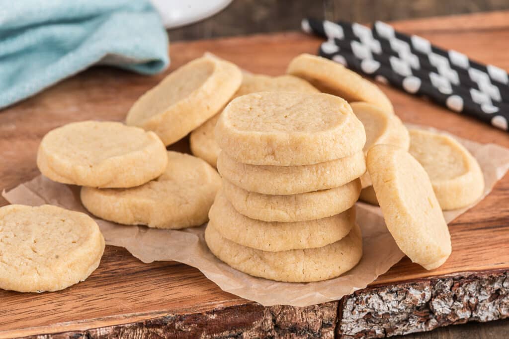 Six cookies stacked with more on the board.