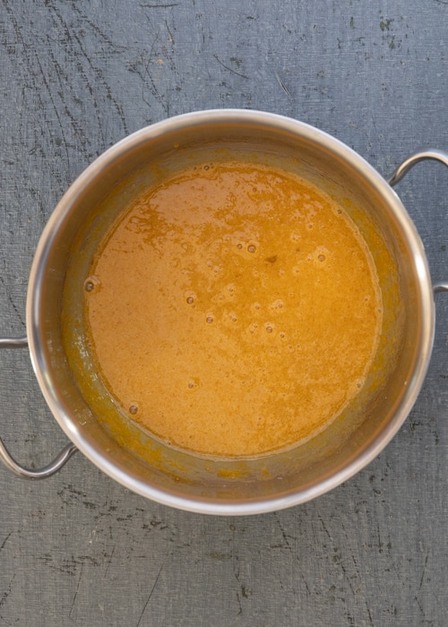 The egg mixture in a silver pot.