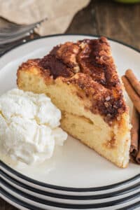 A piece of apple cake with a scoop of ice cream.