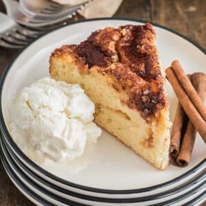 A piece of apple cake with a scoop of ice cream.
