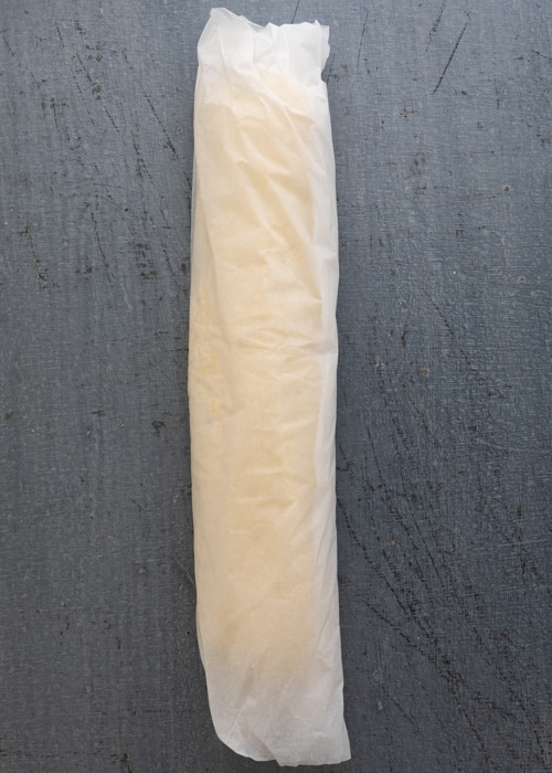 Forming the dough in to a log and wrapped in parchment paper.