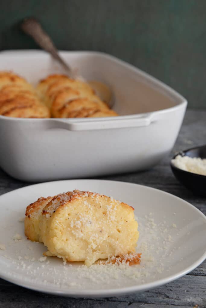 The gnocchi in the pan and some on a white plate.