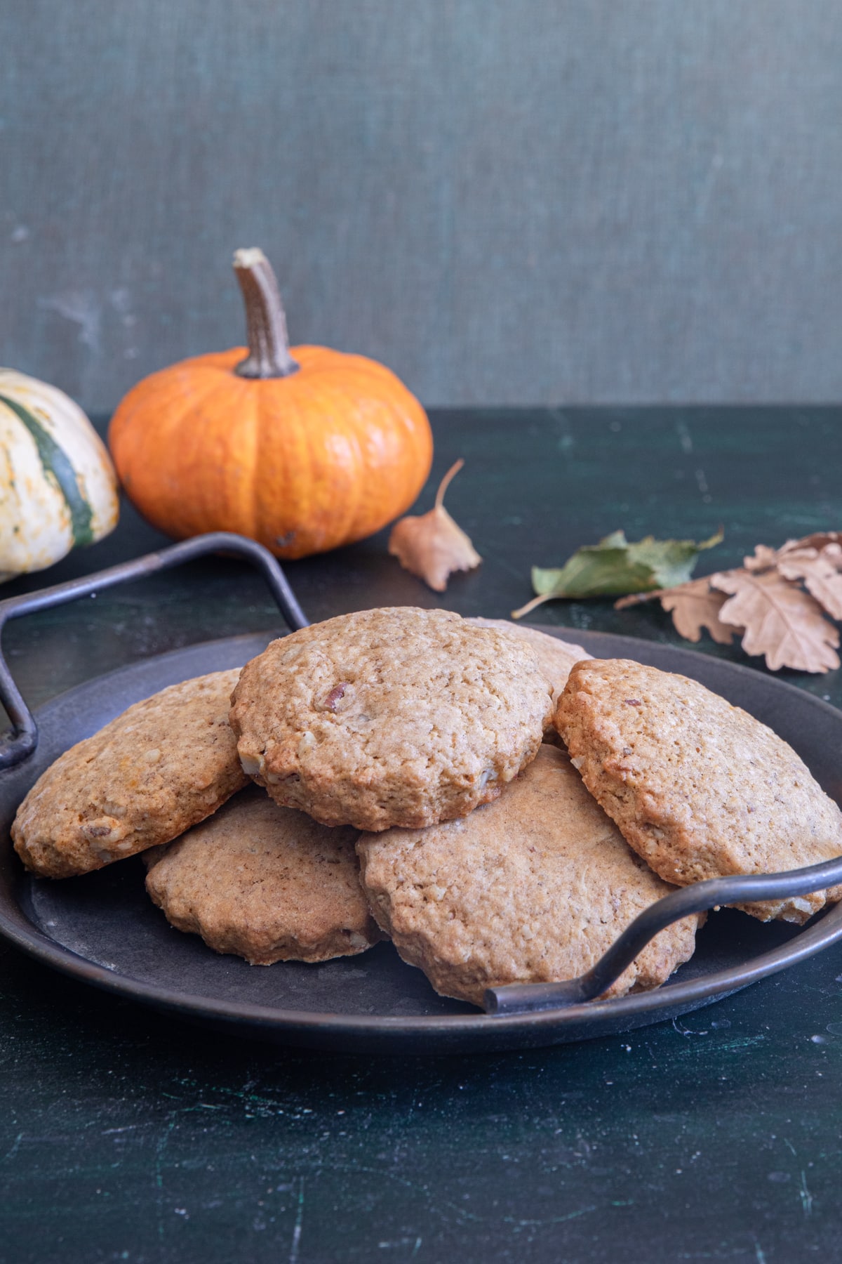 Pumpkin cookies on a black pan.