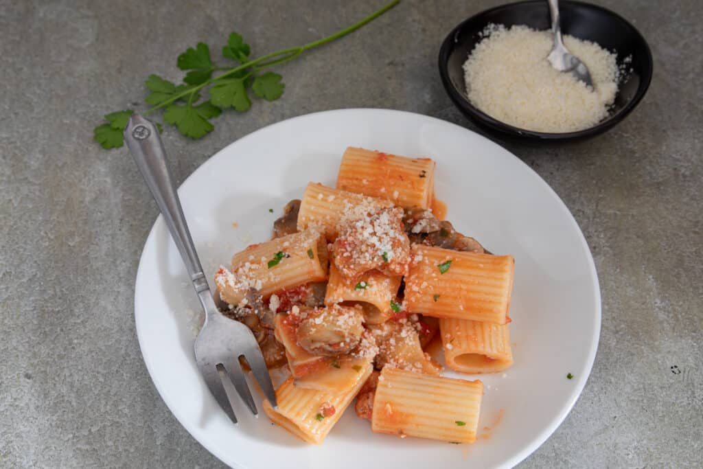 Pasta and sauce on a white plate.