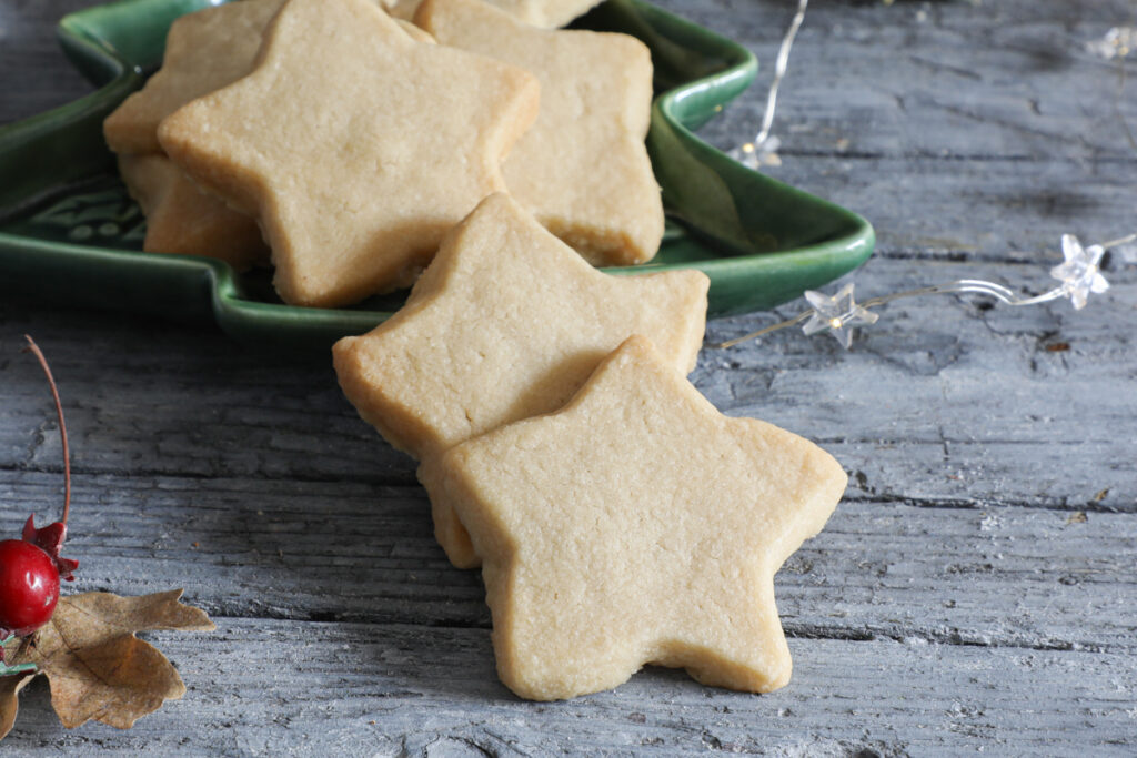 Brown sugar shortbread cookies in a green Christmas tree dish.