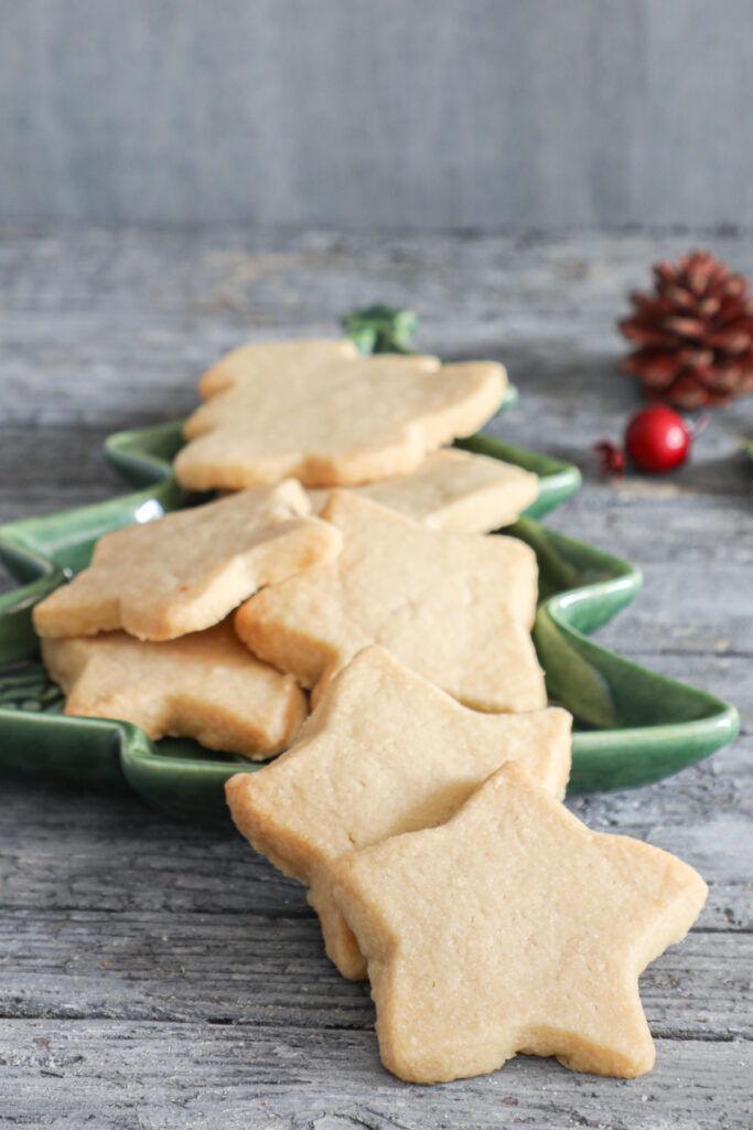 Brown sugar shortbread cookies in a green Christmas tree dish.