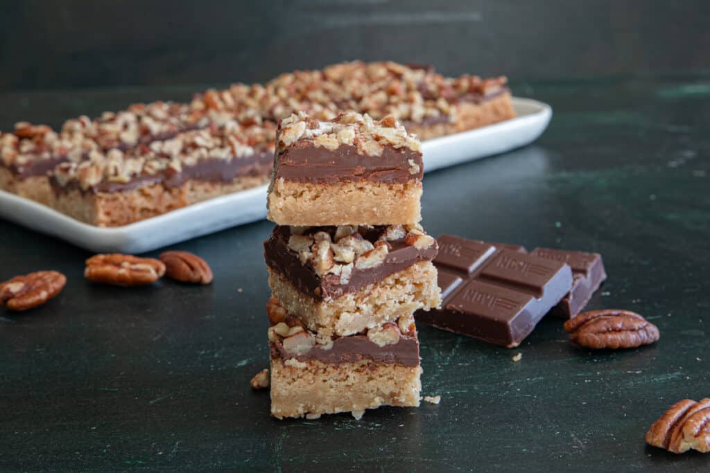 Three bars stacked with some on a white plate.