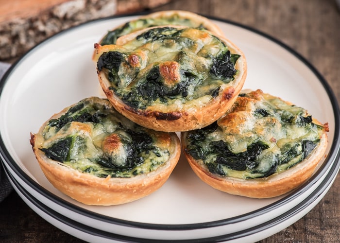 Spinach tarts on a plate.
