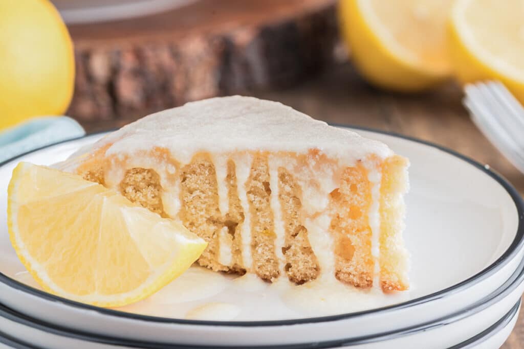 A slice of honey lemon cake on a white plate.