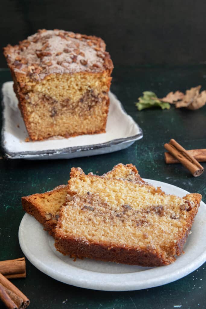 Pecan bread on a white plate with two slices on a round plate.