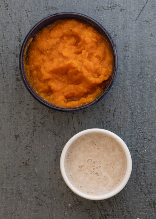 Activated yeast and puree and rosemary in a bowl.