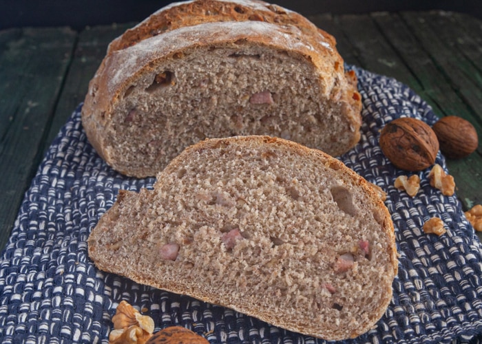 Walnut bread with a slice cut.