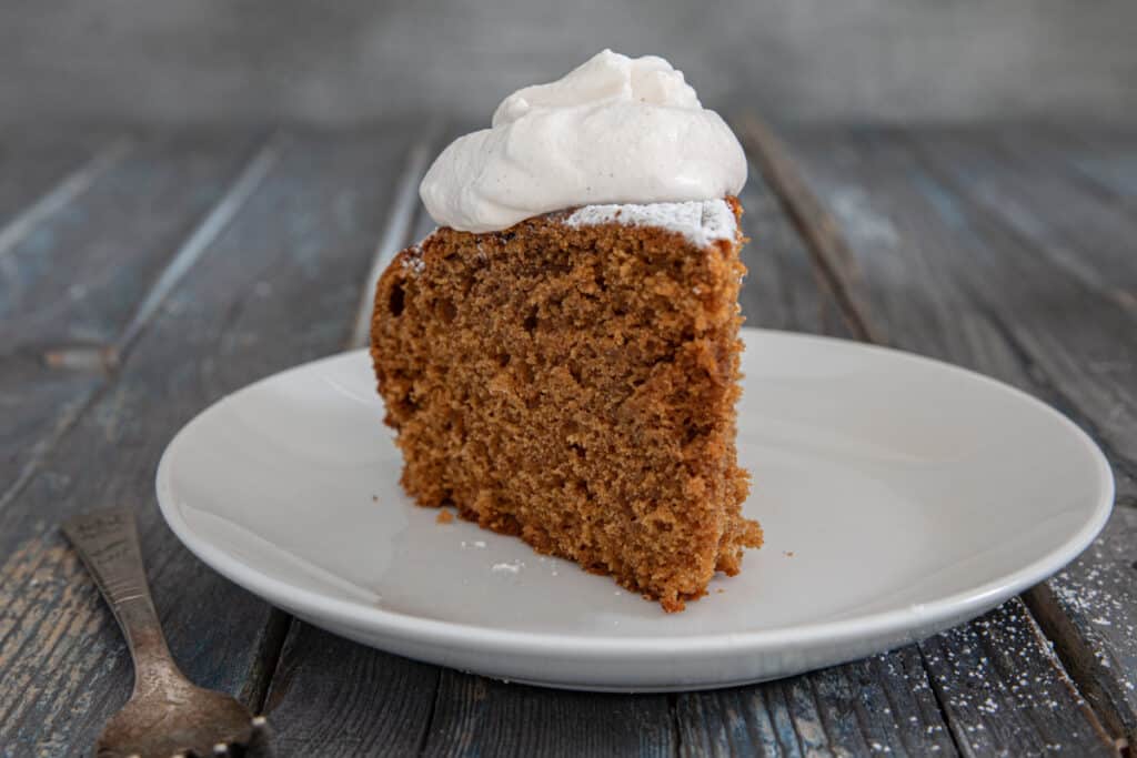 A slice of cake on a white plate.