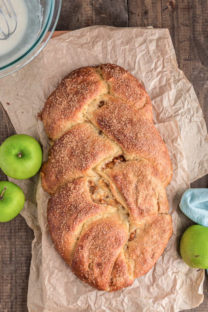 The apple braided bread on a piece of paper.