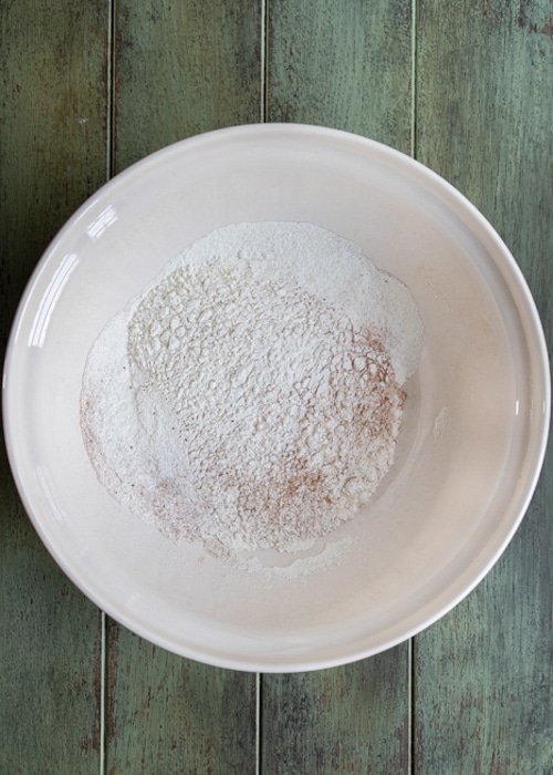 The dry ingredients whisked in a white bowl.