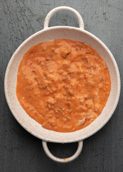 The white sauce the the red sauce in the pan.