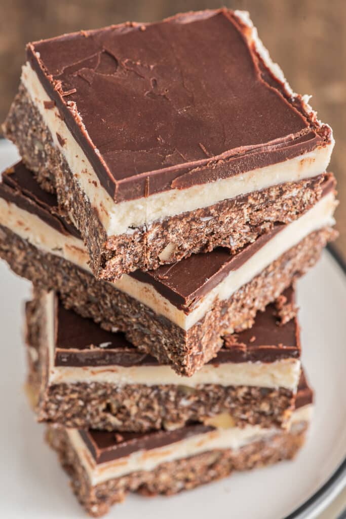 Four Nanaimo bars stacked.