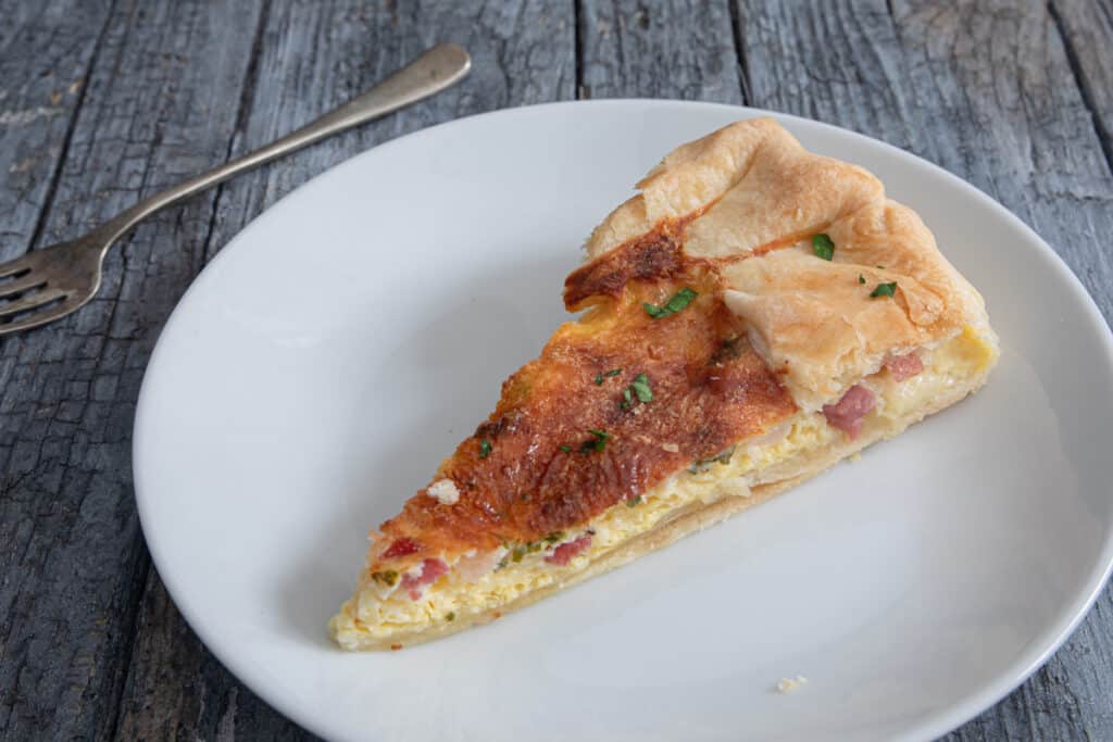 A slice of pie on a white plate.