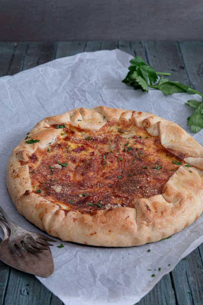 The savory pie on parchment paper.