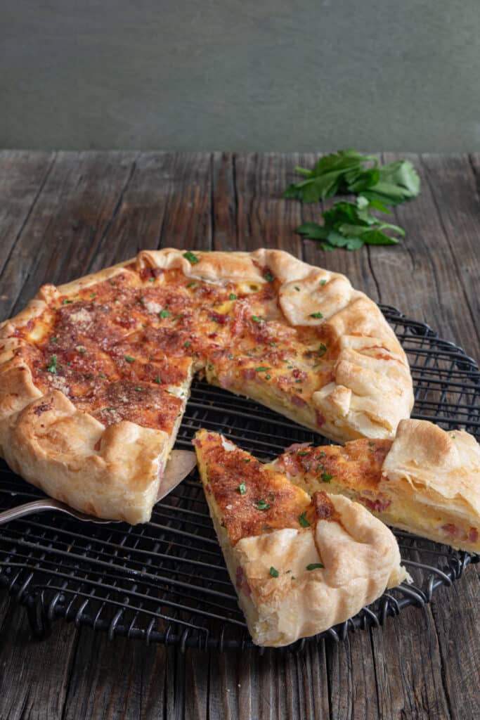 Savory pie with two slices cut.