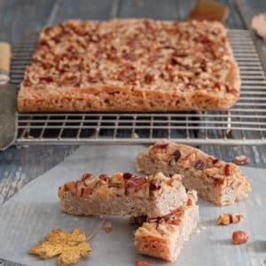 Pecan stick on a wire rack and three on a piece of parchment paper.
