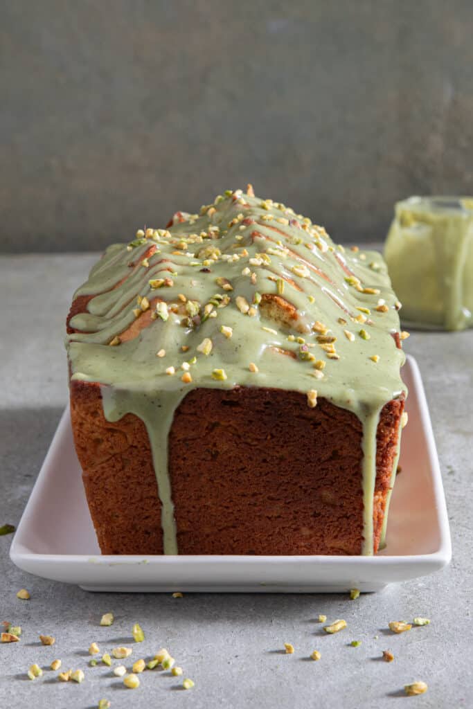 Pistachio bread frosted on a white plate.