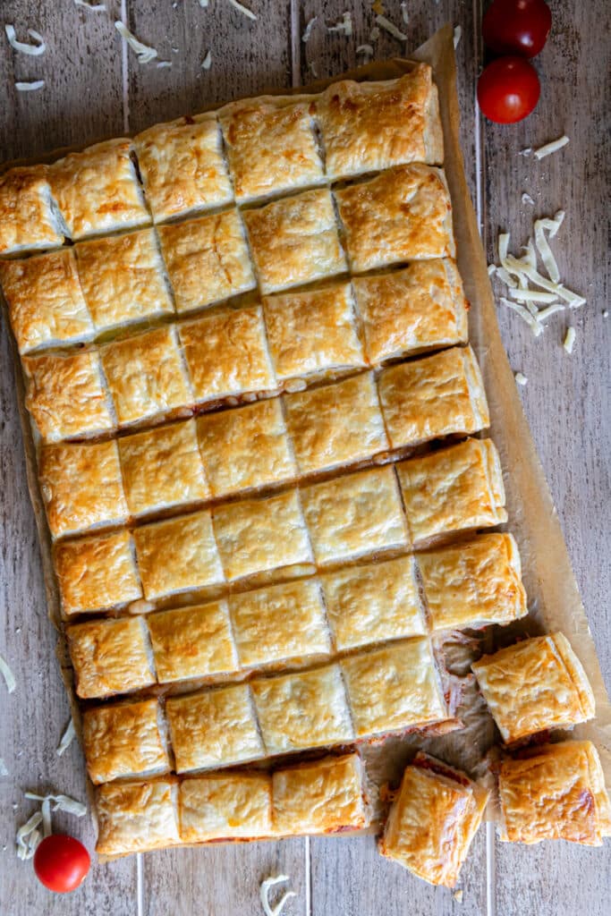 Puff pastry appetizer on a blue board.