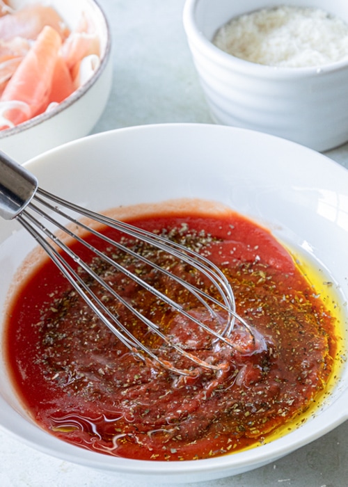 Mixing the sauce in a white bowl.