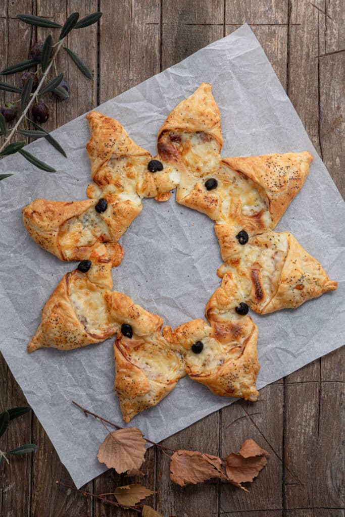 Puff pastry star on parchment paper.