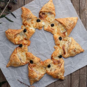 Puff pastry star on parchment paper.