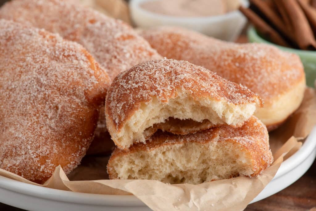 Beaver tails with one cut in half in a plate.
