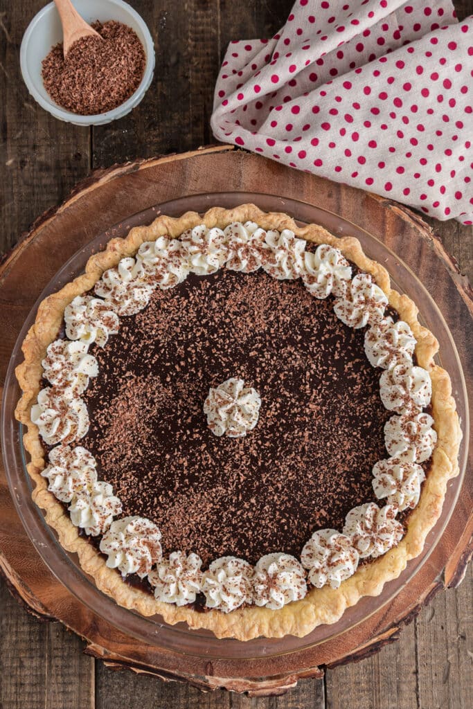 The chocolate cream pie on a wooden board.