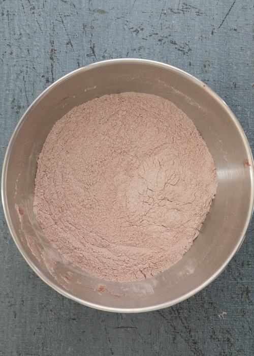 The dry ingredients whisked in a silver bowl.