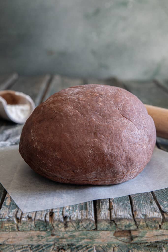 Chocolate pie dough on waxed paper.