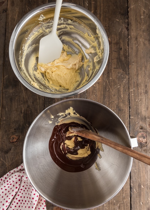 Adding the chocolate to the batter in separate bowls.