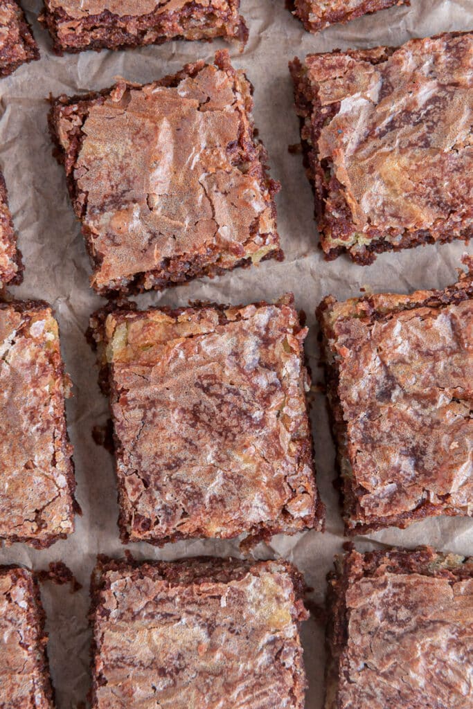 Brownies lined up on paper.