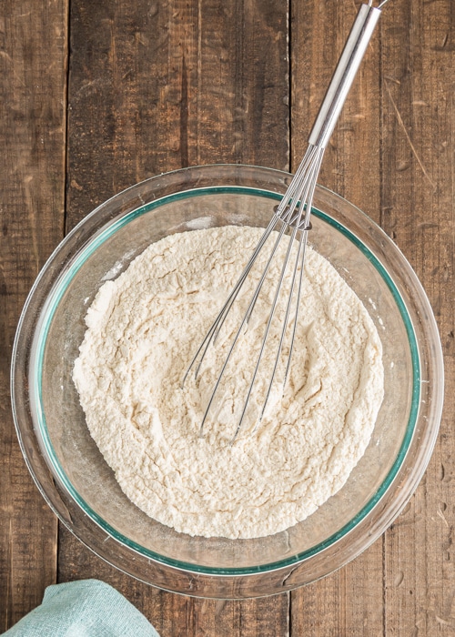 Whisking the dry ingredients in a glass bowl.