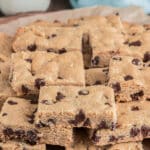 Peanut butter bars on brown parchment paper.