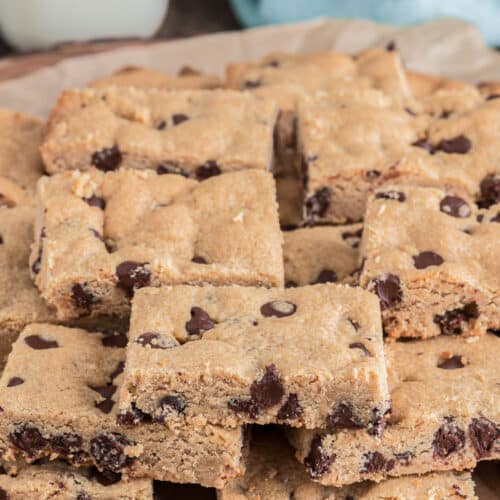 Peanut butter bars on brown parchment paper.