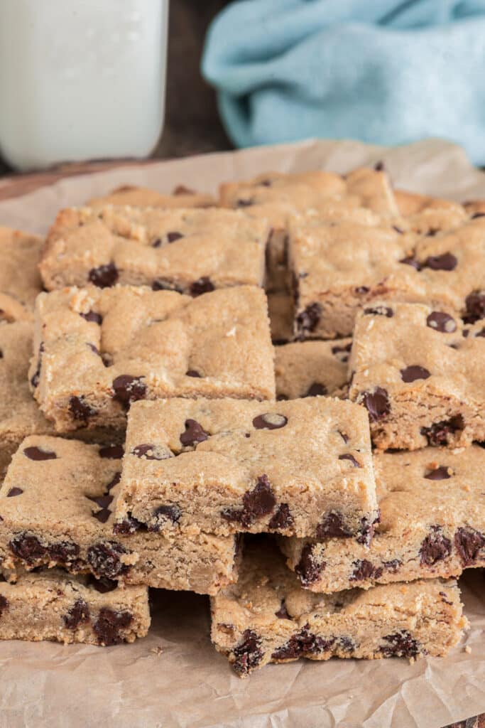 Peanut butter bars on brown parchment paper.