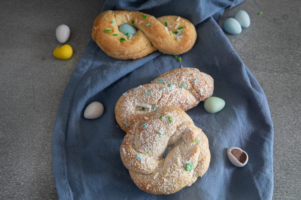 Three cookies on a blue napkin.