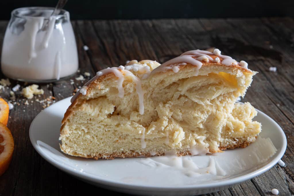 A slice of Brazadel bread on a white plate.
