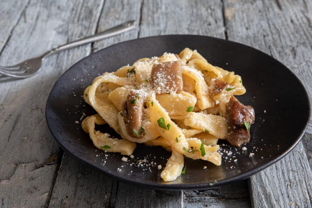 Lievito madre pasta on a black plate.