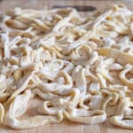 Fresh pasta on a wooden board.